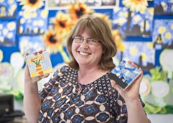 Artist Lorna Watkinson with some painted tiles. Picture by Keith Newman