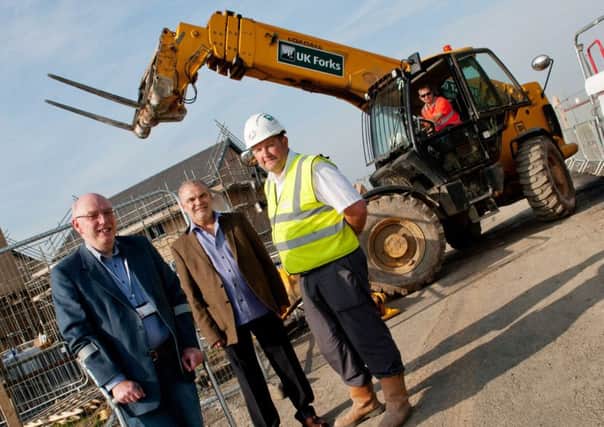 Coun Allan Hepple, centre, at a site in Amble where Northumberland County Council built new social housing.