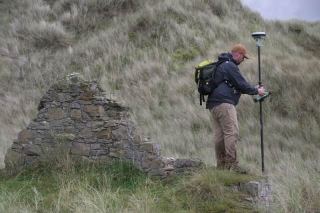 A walkover survey taking place on Holy Island.
