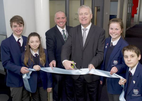 Gary Douglas, interim principal, and Ian Lavery MP open the new building with help from Ashington High School students.