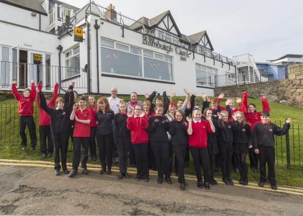 Pupils from Seahouses Middle School and Anne-Marie Trevelyan outside the Bamburgh Castle Inn.