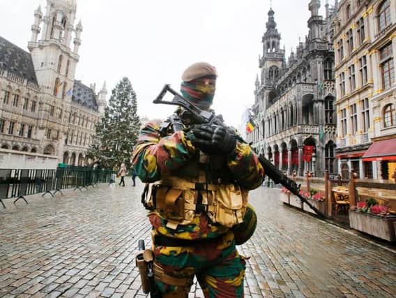 A Belgium police officer patrols the Grand Place in central Brussels, Belgium, in November when terror alerts where on their highest level. (AP Photo/Michael Probst)