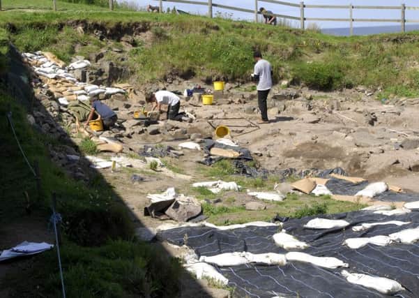 Students at work in the trenches of the Bamburgh Research Project at Bamburgh Castle.