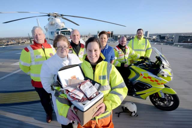 Members of the Great North Air Ambulance team with hospital staff on the roof of the Royal Victoria Infirmary (RVI) hospital in Newcastle, where they launched the new scheme which will see the craft start to carry blood on board. Picture by Will Walker/NNP