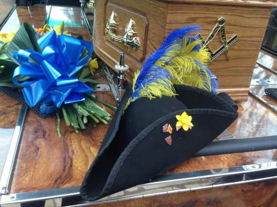 John's town crier hat in the hearse.