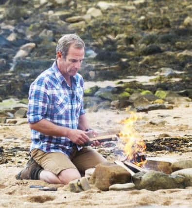 Robson Green on a secluded Northumberland beach 
cooks his supper of seaweed and limpets. Picture courtesy of ITV