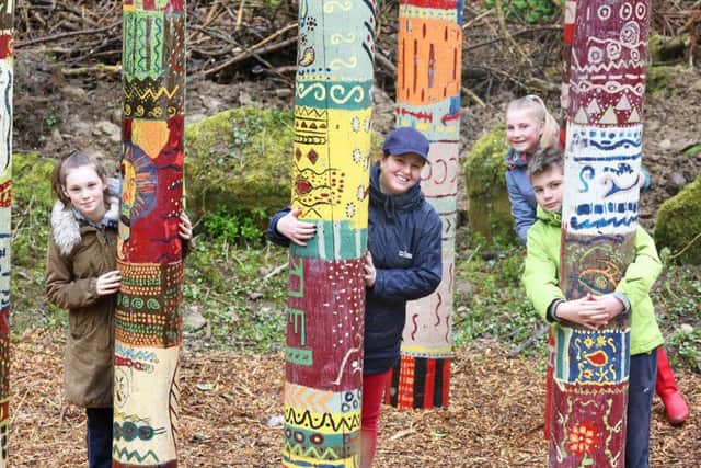Abbie Hulme, Louise Short and Brook Miller with Isos community involvement team leader Sara Parker-Clark among the colourful totem poles.