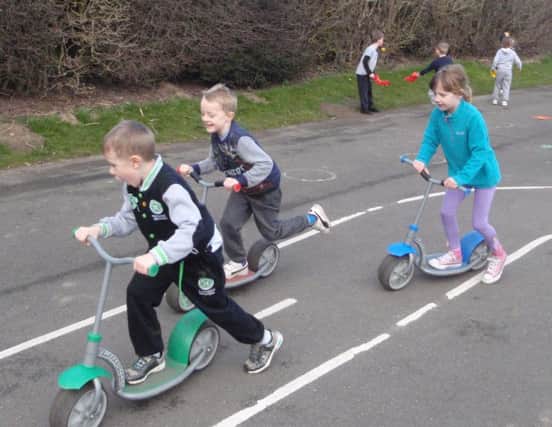 Longhoughton pupils racing their scooters.