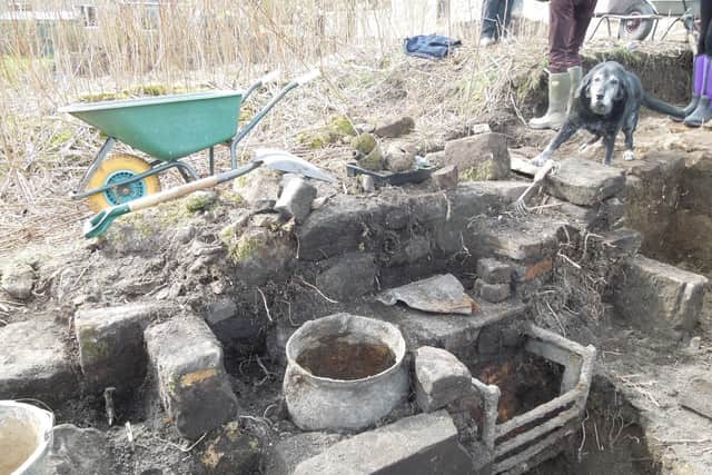 A kitchen range, complete with family-sized cauldron, has been unearthed from the Victorian cottages which were built on top of the original priory buildings.