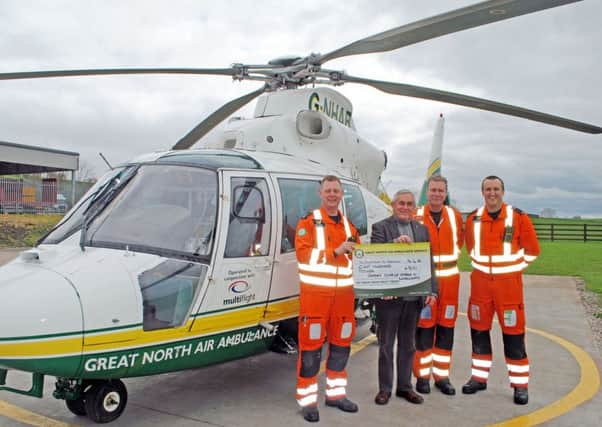 Pictured at the air ambulance are left to right: Andy Dalton (Paramedic), Dave Shoemaker, President of the Rotary Club of Amble & Warkworth, Jay Stewart (Pilot) and Dr Jonathan Howes.  The money was raised from the club's annual Christmas collection.