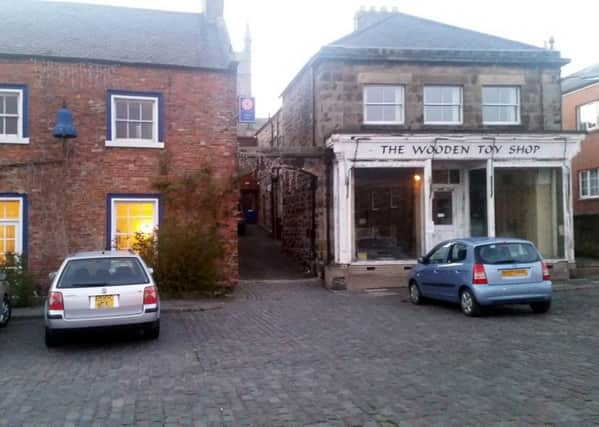 Concerns have been raised about parked cars blocking the alley between the Blue Bell Hotel and the Wooden Toy Shop.