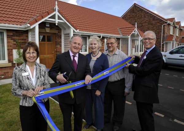 Lord Beith, second left, at the opening of the Kennedy Green development of affordable homes in Beadnell in 2012.