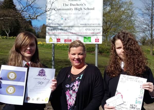 Pupils Lauren Carr and Brooke Ryder with their winning designs for the Shepherds Fest tickets. They are pictured with event organiser Linda Gaines.