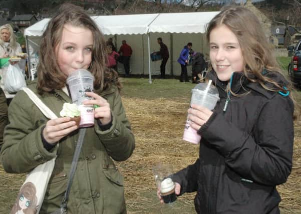 Twelve-year-olds Danielle Gutherson and Megan Tombs, both from Rothbury, tuck into some goodies. Picture by Mary Scott
