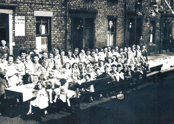 In May 1945 the Shields Evening News reported on Victory Tea Parties across the borough and captioned this image kiddies and grown ups in happy mood at Laet Street, North Shields.