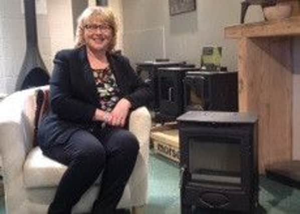 Competition winner Cindy Fairbairn with the new woodburning stove.