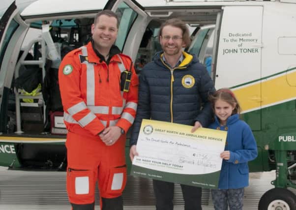 Neil Wilson with his daughter and Great North Air Ambulance Service aircrew doctor Dion Arbid.