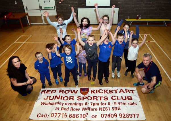 Lindsey Porter from Isos with John Robertson of Red Row Kickstart and some of the children who attend the club each week.