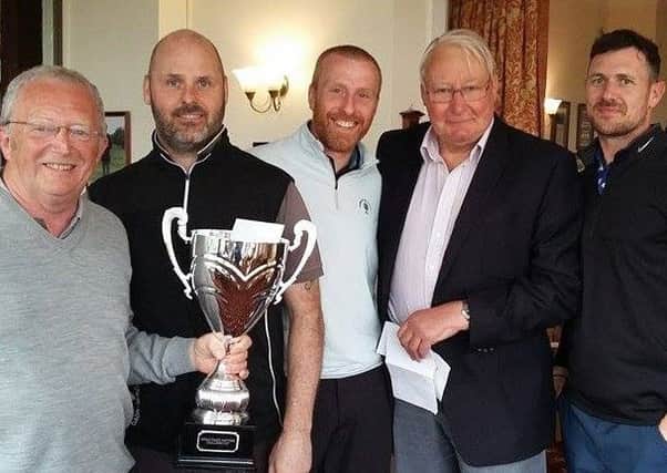 Tom Batey, Sturton Grange Developments Ltd, left, and Peter Slee, chairman of HospiceCare North Northumberland, second right, with the winning team.