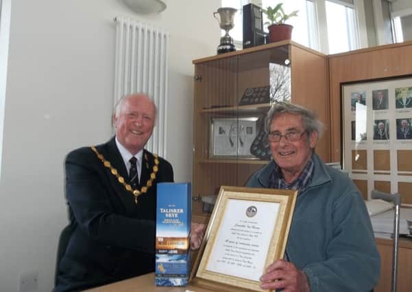 Outgoing Amble Mayor Craig Weir presented a certificate and bottle of alcohol to Coun Ian Hinson to recognise his 40 years of service.