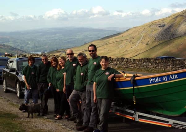 The Alnmouth Community Rowing team atop Kirkstone Pass with Windermere just visible in the background.