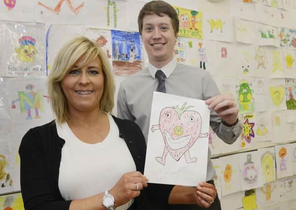 Carolyn Gibson from Morrisons and Ben O'Connell from the Northumberland Gazette with the winning mascot design at the Alnwick store. 
Picture by Jane Coltman