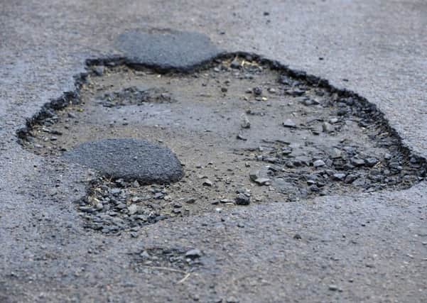 The pothole repairs process needs to improve.
