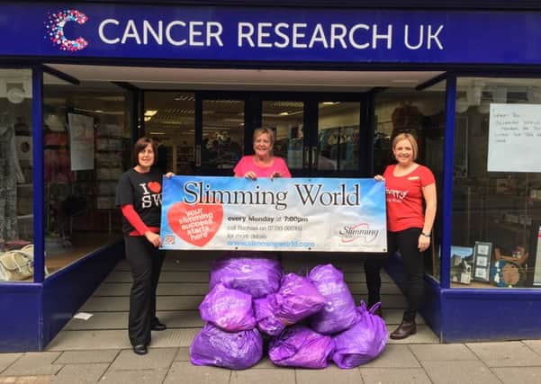 Slimming World Big Clothes Throw. Alnwick Consultants Lorna Daniels and Rachael Bewley with Libby from the Alnwick Cancer Research Shop.
