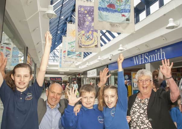 Pupils from the Dales School, Blyth; Trevor Gyllenspetz, centre manager, The Keel Row Shopping Centre; and Coun Kath Nisbet (far left); and the Tall Ships banners in the Keel Row Shopping Centre.