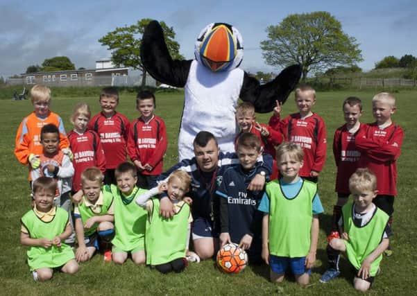 Festival mascot Tommy Noddy with junior footballers and Tiny Woods Football Academy coach Josh Rutherford. Picture by Anna Williams/The Ambler