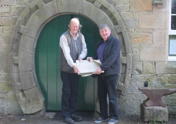 Peter Fagan and John Marrin with the newspapers outside Horseshoe Forge Antiques in Ford Village.