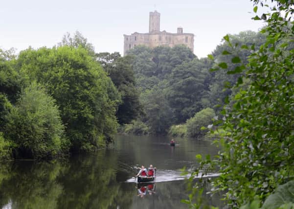 Summer view of Warkworth castle and river.