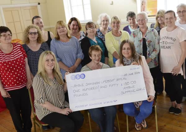 Louise Greenaway and Rachael Green from the Amble branch of Slimming World, along with some of their members, present Â£150 to Eleanor Cassidy  of the RNLI Shannon Appeal.
Picture by Jane Coltman