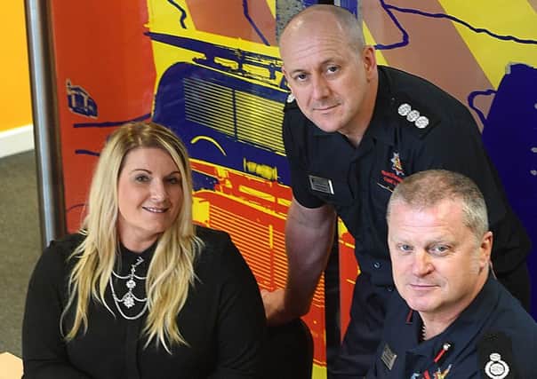 Emily Pearson, from Mind, with Andy Davison and Assistant Chief Fire Officer Mark McCarty, from Northumberland Fire and Rescue Service. Picture by Doug Moody