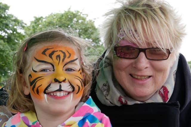 Three-year-old holidaymaker Poppy Maeer, from Leeds, gets the tiger treatment from face-painter Julie Charlton. Picture by Dave Foster