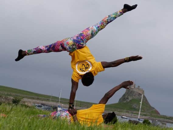 Acrobats Moses Opiyo and Francis Odongo show off their skills to Let's Circus visitors during the festival. Picture by Dave Foster