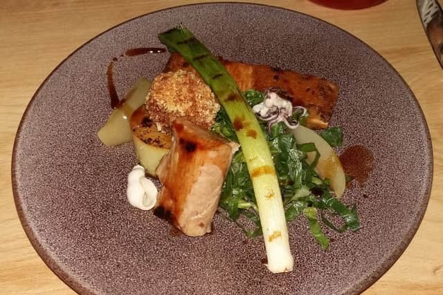 Slow-roasted belly pork, crispy pig cheek, lime and tarragon squid, sour pineapple, fondant potato and greens (Â£15.95).