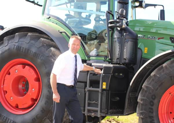 Duncan Lambert, director of Rix Petroleum, alongside the modern diesel tractor that would benefit from Gas Oil Plus.