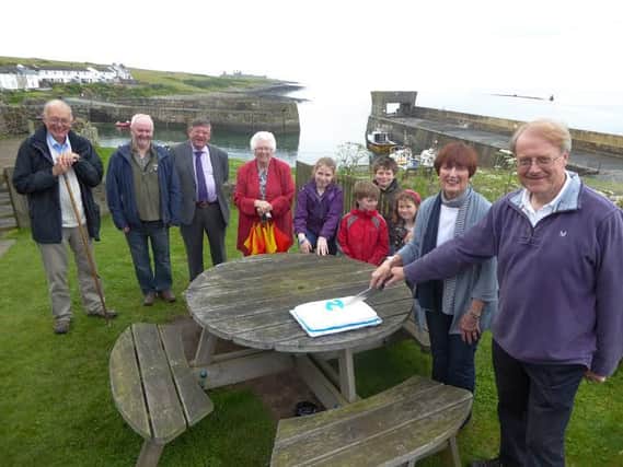 Cllr John Woodman and former Chair of the AONB Partnership, Pat Scott, cut the cake to mark the group's 10th anniversary.