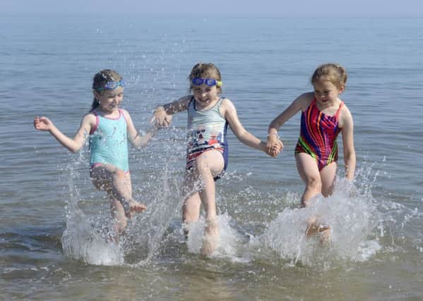 Splashing! Youngsters enjoy the glorious weather at Alnmouth beach. Picture by Jane Coltman