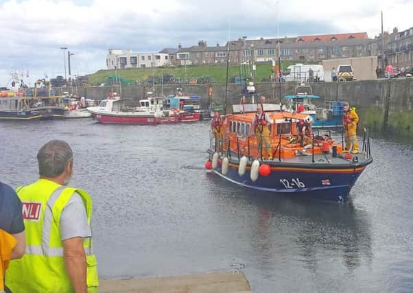 The lifeboat returns to Seahouses with the Inner Farne casualty on deck.