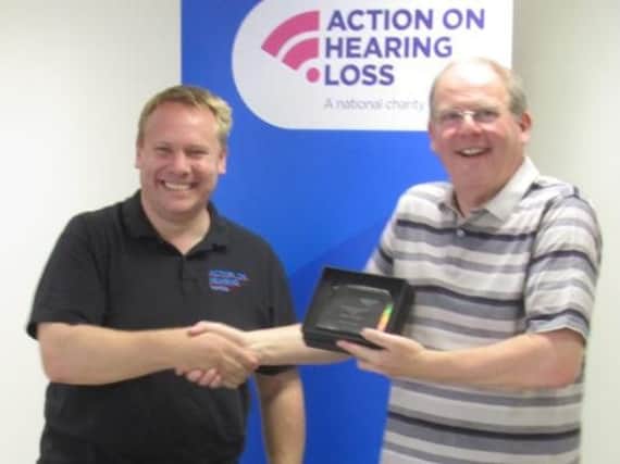 Michael Holroyd (right) with his Action on Hearing Loss Award, being presented by Paul Breckell (left), Chief Executive of Action on Hearing Loss.