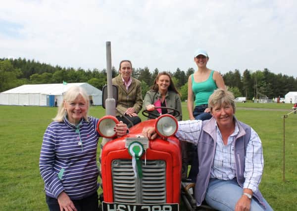Rachael Tait in the driving seat, with members of the Glendale Agricultural Society Committee who will be celebrating the Year of the Lady at Glendale Show.