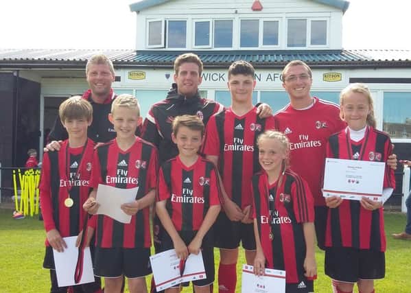 The six youngsters selected to go to Italy next year are pictured with coaches from AC Milan at Alnwick Town.