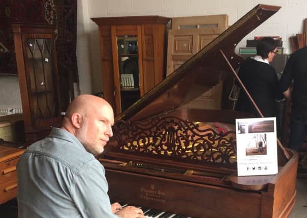 Professional pianist Mark Deeks, from Blyth, playing the vintage Steinway piano before its sale raised Â£7,200 for St Oswalds Hospice.