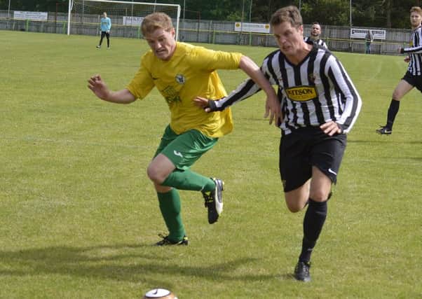 Alnwick Town's Tony Brown takes on an Esh Winning player in their opening game of the new season. Picture by Jason Sumner