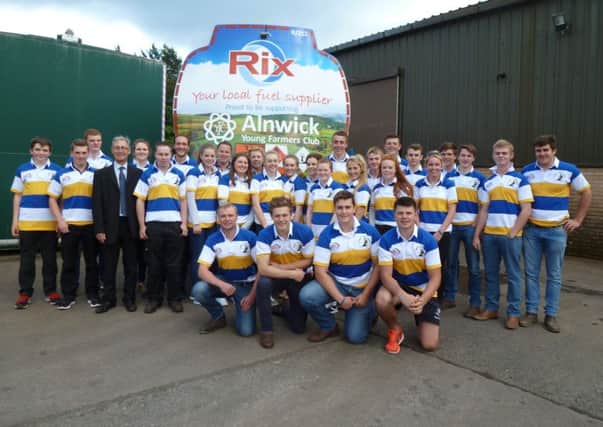 Tim Claxton (wearing suit), manager of Rix Petroleums Alnwick depot, with members of Alnwick Young Farmers.