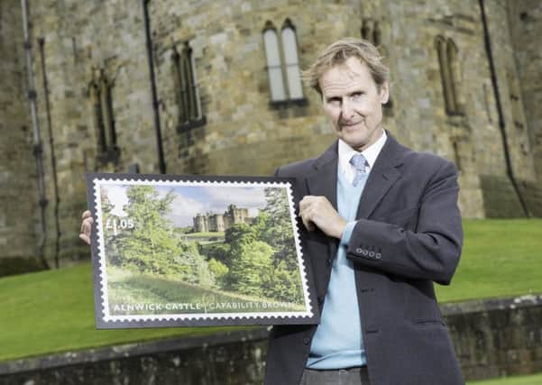 The Duke of Northumberland with the commemorative stamp featuring Alnwick Castle.