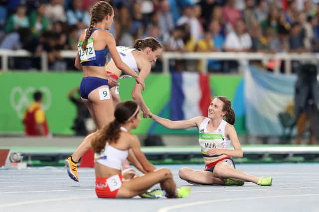 Laura Weightman shakes the hands of Team GB colleague Laura Muir (sitting down) after the final.