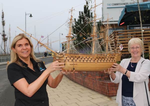 Catherine Bellhouse (left) and Margaret McBriarty hold the model of HMS Victory.